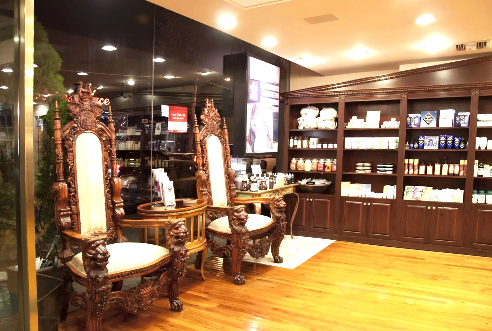 Salon retail area with carved lion chairs and wooden product shelves